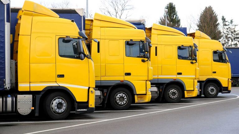 Camiones amarillos estacionados en una carretera